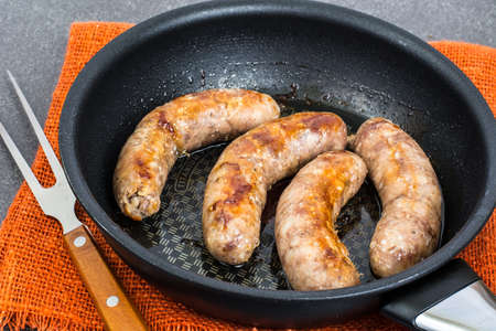 Sausage home pork, fried in frying pan. Studio Photoの写真素材