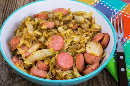 Sliced pork sausages with cabbage in ceramic bowlの写真素材