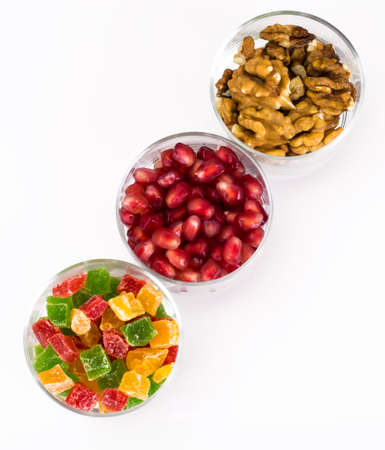 Small glass with dried fruits, nuts, pomegranateの写真素材