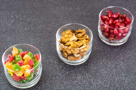 Small glass with dried fruits, nuts, pomegranateの写真素材