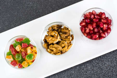 Small glass with dried fruits, nuts, pomegranateの写真素材