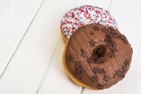 Delicious donuts on white wooden backgroundの写真素材