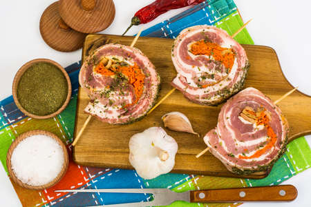 Raw meat rolls on wooden skewers for fryingの写真素材