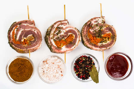 Raw meat rolls on wooden skewers for fryingの写真素材