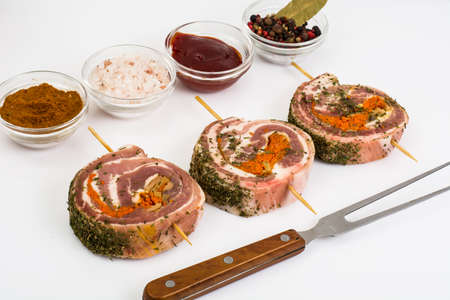Raw meat rolls on wooden skewers for fryingの写真素材