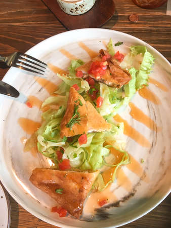 Leaf salad with grilled cheese, fruit dessert, cappuccino, latte