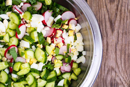 Sliced cucumber, radish, onion, spinach, lettuce and egg in metaの写真素材