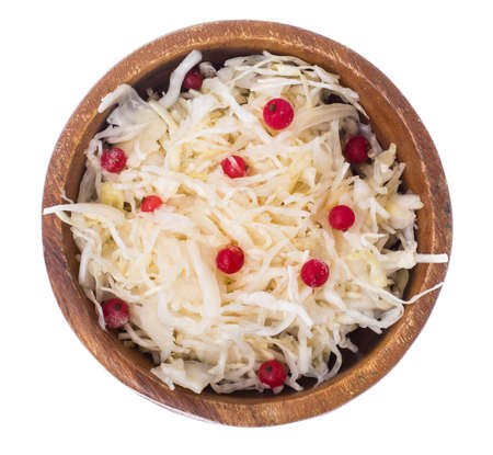 Sauerkraut with cranberries in wooden bowl on white backgroundの写真素材