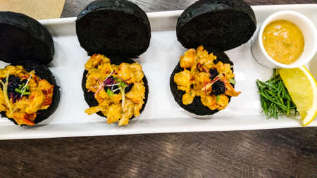 Dishes of seafood lobster slices on bread