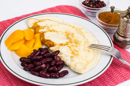 Omelette in plate, sweet yellow pepperの写真素材