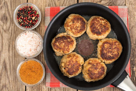 Tasty fried chops in frying pan