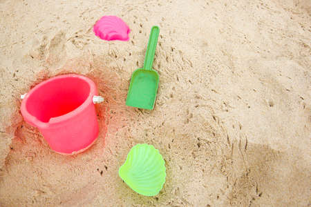 Childrens pail and colored molds on the beach in the sandの写真素材