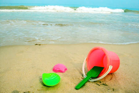 Childrens pail and colored molds on the beach in the sandの写真素材