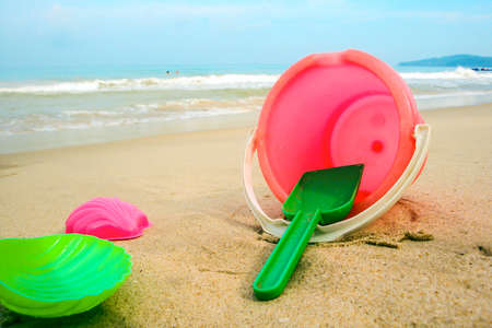 Childrens pail and colored molds on the beach in the sandの写真素材