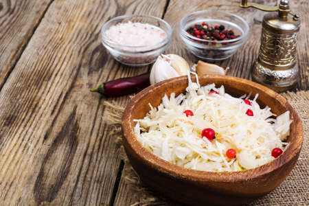 Salted cabbage on plate on the background of wooden table. Studio Photoの写真素材