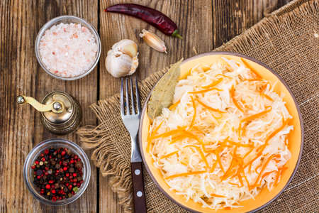 Salted cabbage on plate on the background of wooden table. Studio Photoの写真素材