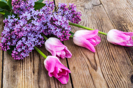 Bouquet of tulips with lilac on wooden background. Studio Photoの写真素材