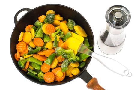 Frozen vegetables in cast-iron frying pan. Studio Photoの写真素材