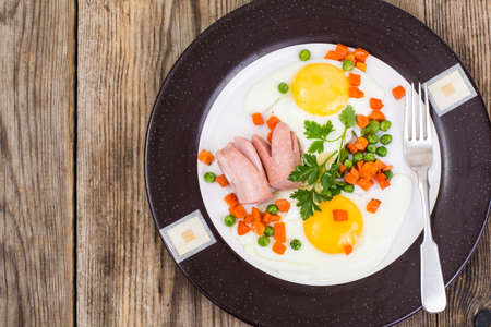 Plate with fried eggs and steamed vegetables for breakfast. Studio Photoの写真素材