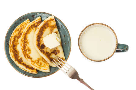 Tasty fried pancakes with milk in cupの写真素材