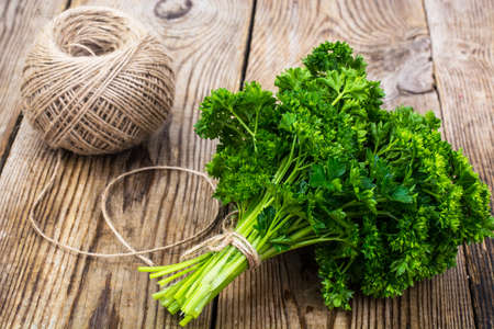 Organic fresh parsley on wooden surfaceの写真素材