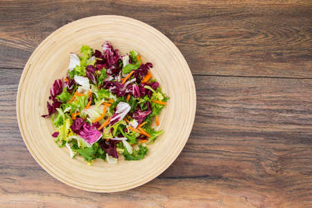 Mix salads with pomegranate and hamの写真素材