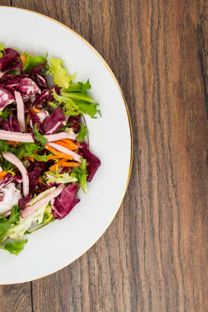 Mix salads with pomegranate and hamの写真素材