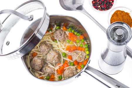 Soup with meatballs on white backgroundの写真素材