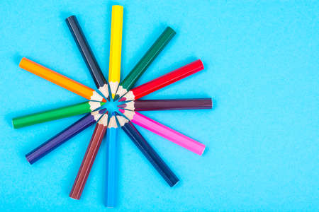 Stationery: colored pencils on blue background.の写真素材