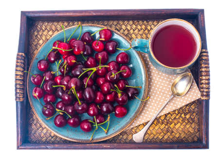 Cherry compote and ripe berries on tray. Studio photoの写真素材