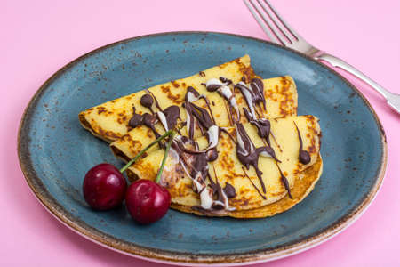 Sweet pancakes with chocolate topping on pastel background. Studio Photoの写真素材