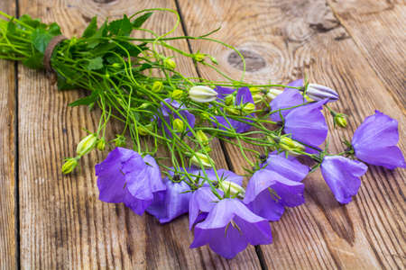 Bouquet with blue flowers on wooden table.の写真素材