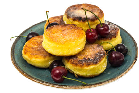 Sweet cottage cheese pancakes with powdered sugar on plate on whの写真素材