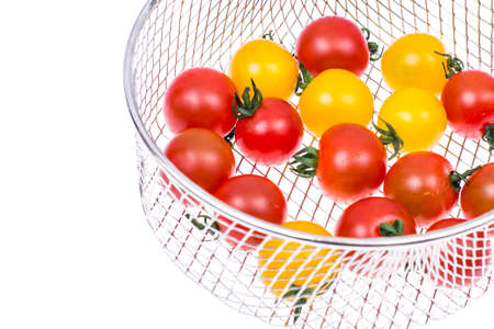 Small colored cherry tomatoes on white backgroundの写真素材