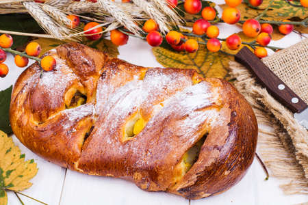 Roll with apples and raisins on Harvest holiday. Studio Photo