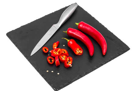 Spice in cooking red chili pepper on black stone. Studio Photo