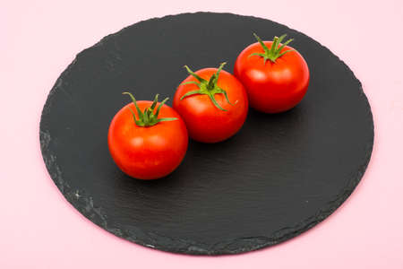 Creative layout made from red tomatoes on bright backgroundの写真素材