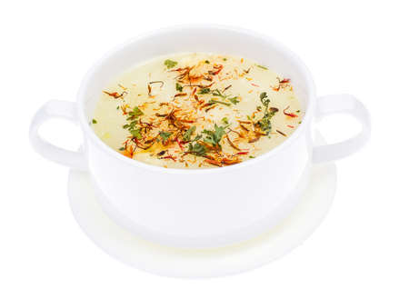 Vegetable soup with saffron in white bowlの写真素材
