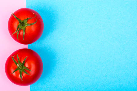 Pastel bright background with red tomatoesの写真素材