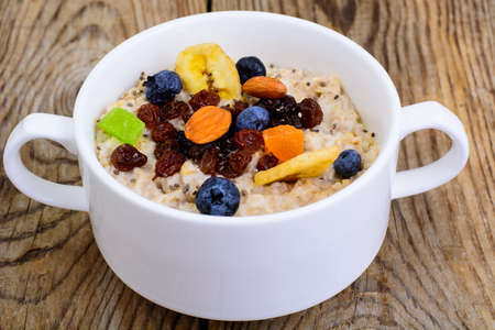 Porridge from oatmeal for breakfastの写真素材