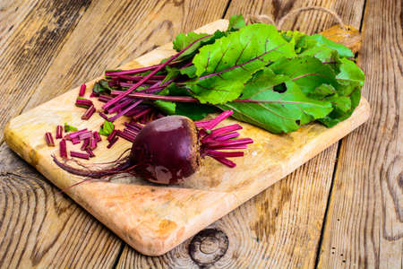 Fresh raw beetroot, sliced on kitchen cutting boardの写真素材
