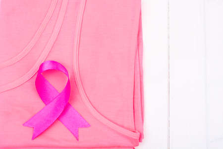 Healthcare and medicine  symbol - pink breast cancer awareness ribbon on female shirtの写真素材