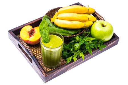 Fresh organic green cocktail made from fruits and vegetables as a healthy drink on wooden tray. Studio Photoの写真素材