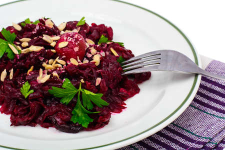 White plate with snack of beet and seedsの写真素材