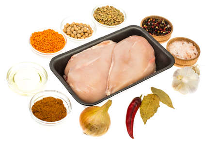 Fresh raw chicken breast with spices on white backgroundの写真素材