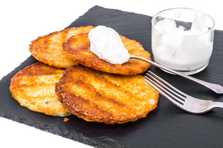 Potato pancakes with white sauce.の写真素材