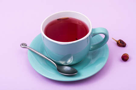 Cup with red tea on pink backgroundの写真素材