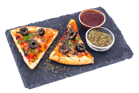 Pizza slices with ketchup and oregano