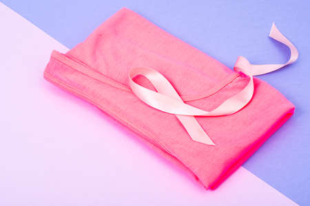 Pink ribbon on bright background-a symbol of awareness of breast cancerの写真素材