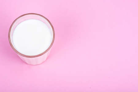Glass with milk on bright backgroundの写真素材
